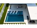 Modern, expansive pool with spa, and a covered patio area at 526 First Cape Coral Dr, Winter Garden, FL 34787