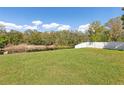 Expansive backyard featuring lush green grass and serene pond views at 6121 Bass Hwy, St Cloud, FL 34771