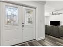 Home's double front doors leading to a living room with wood flooring at 6121 Bass Hwy, St Cloud, FL 34771
