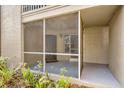 View of the home's screened porch, front door, and landscaping provides secure outdoor space at 629 Dory Ln # 108, Altamonte Springs, FL 32714
