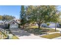House with a spacious yard, driveway, and neighboring houses visible at 1921 Nicholas Pl, St Cloud, FL 34771