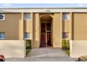 Exterior view of apartment building entrance with stairs and landscaping at 1000 Lake Of The Woods Blvd # 203E, Casselberry, FL 32730