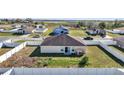 Aerial shot of a fenced backyard with a sliding glass door leading to the interior of the home at 1317 Conch Key Ln, Davenport, FL 33837