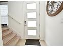 Front entry with modern door, stairs, and decorative wall art at 1389 Captiva Cv # 20, Sanford, FL 32771