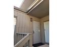 Private condo entrance with a light fixture and railing at 203 Crown Oaks Way # 202, Longwood, FL 32779