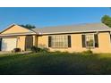 Charming single-story home featuring a well-maintained lawn and manicured landscaping at 2537 Lanier Rd, Kissimmee, FL 34744