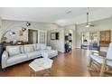 Bright living room with vaulted ceilings, hardwood floors, modern furnishings and French doors to other room at 2537 Lanier Rd, Kissimmee, FL 34744