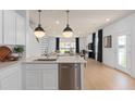 Open concept kitchen with island, stainless steel appliances, and view of living room at 2575 Winsome Way, Davenport, FL 33896