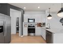 Modern kitchen with white cabinets, stainless steel appliances, and quartz countertops at 2575 Winsome Way, Davenport, FL 33896