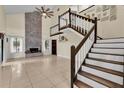 Spacious living room with high ceilings, a fireplace, and a staircase at 377 River Chase Dr, Orlando, FL 32807