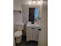 Bathroom with modern fixtures, a vanity with storage, stylish mirror, and modern toilet at 417 Benita St, Kissimmee, FL 34744