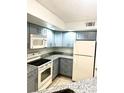 Modern kitchen with gray cabinets and granite counters at 4524 Commander Dr # 1613, Orlando, FL 32822