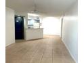 Open living room with tile floors and kitchen view at 4524 Commander Dr # 1613, Orlando, FL 32822