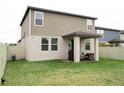 Grass backyard with a patio, sitting area, and privacy fence at 494 Amadoras Way, St Cloud, FL 34771