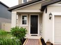 House entrance with a black door, brick walkway, and welcome sign at 494 Amadoras Way, St Cloud, FL 34771