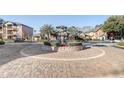 Community entrance with a circular fountain and landscaping at 5961 Westgate Dr # 2034, Orlando, FL 32835