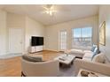 Living room with light walls, hardwood floors, and staged furniture at 5961 Westgate Dr # 2034, Orlando, FL 32835