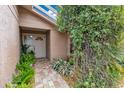 Front entry with white door, brick pathway, and lush greenery at 615 Tuskawilla Point Ln, Winter Springs, FL 32708