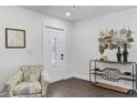 Bright foyer with wood-look floors, modern decor, and a stylish accent chair at 720 Jasmine Ave, Orange City, FL 32763