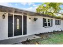 Close up of front exterior featuring a glass paneled door and decorative planters at 720 Jasmine Ave, Orange City, FL 32763