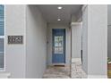 Modern front door entry with stone accents and a welcoming mat at 7783 Westland Dr, Kissimmee, FL 34747