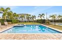 Inviting community pool with a spa and lounge chairs at 7783 Westland Dr, Kissimmee, FL 34747
