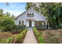 Charming light blue house with white picket fence and landscaped yard at 810 E Central Blvd, Orlando, FL 32801
