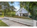 Gray house with white picket fence, well-manicured lawn, and walkway at 810 E Central Blvd, Orlando, FL 32801