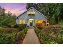 Charming home featuring landscaped front yard, well-manicured hedges and inviting walkway at 810 E Central Blvd, Orlando, FL 32801