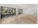 Bright living room with tile floors and sliding glass doors leading to a patio at 90 Moree Loop # 15, Winter Springs, FL 32708