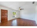 Bright living room featuring wood-look floors and a ceiling fan at 1006 Center St, Ocoee, FL 34761