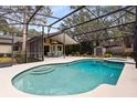 Inviting pool area with screened enclosure at 1107 Pheasant Cir, Winter Springs, FL 32708