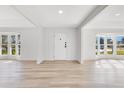 Bright and airy entryway with light wood flooring and bay windows at 1203 Waverly Way, Longwood, FL 32750