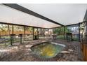 Relaxing backyard spa inside a screened enclosure, featuring string lights and a brick-paved patio at 1222 Golfview St, Orlando, FL 32804