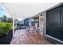 Inviting front porch with brick flooring, rocking chairs, and a 'Welcome' sign for a cozy entrance at 1222 Golfview St, Orlando, FL 32804