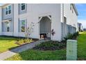 Front entryway with covered porch, landscaping, and walkway at 1274 Shoreside St, Clermont, FL 34714