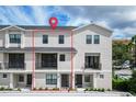 Two-story townhome with modern exterior and balcony at 12964 Brandon Coates Dr, Orlando, FL 32828