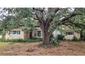 Ranch-style home with mature landscaping and brick facade at 1425 N Hiawassee Rd, Orlando, FL 32818