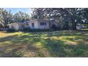 House with mature trees and yard at 1425 N Hiawassee Rd, Orlando, FL 32818