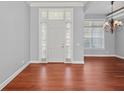 Bright entryway with hardwood floors and a classic white door at 1470 Place Picardy, Winter Park, FL 32789