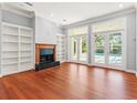 Spacious Gathering room with hardwood floors, built-in shelving, and fireplace at 1470 Place Picardy, Winter Park, FL 32789