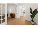 Light and bright hallway with wood floors and French doors at 15944 Citrus Knoll Dr, Winter Garden, FL 34787