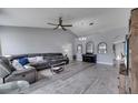 Spacious living room with gray tones, vaulted ceilings, and sleek, modern flooring at 1834 Roper Rd, St Cloud, FL 34771