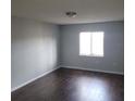 Simple bedroom with dark wood floors and light walls at 1928 Conway Rd # 23, Orlando, FL 32812