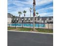 Community pool with palm trees and surrounding buildings at 1928 Conway Rd # 23, Orlando, FL 32812