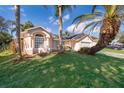 Two-story house with a landscaped yard and palm trees at 2006 Key Lime St, Ocoee, FL 34761