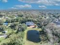 Aerial view showing the house, pond, and surrounding neighborhood at 2323 Tuskawilla Rd, Oviedo, FL 32765