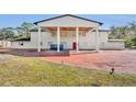 House exterior showcasing a large covered entryway and brick pavers at 2323 Tuskawilla Rd, Oviedo, FL 32765