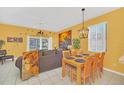 Dining area with wood table and yellow walls at 2720 Bushman Dr, Kissimmee, FL 34746