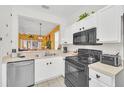 Kitchen with stainless steel appliances and white cabinets at 2720 Bushman Dr, Kissimmee, FL 34746